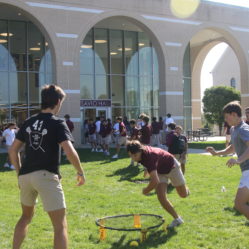 A group of Don Bosco Students playing spike ball outside having fun